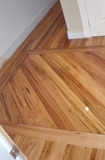 Stringybark strip flooring entry border, gloss finish